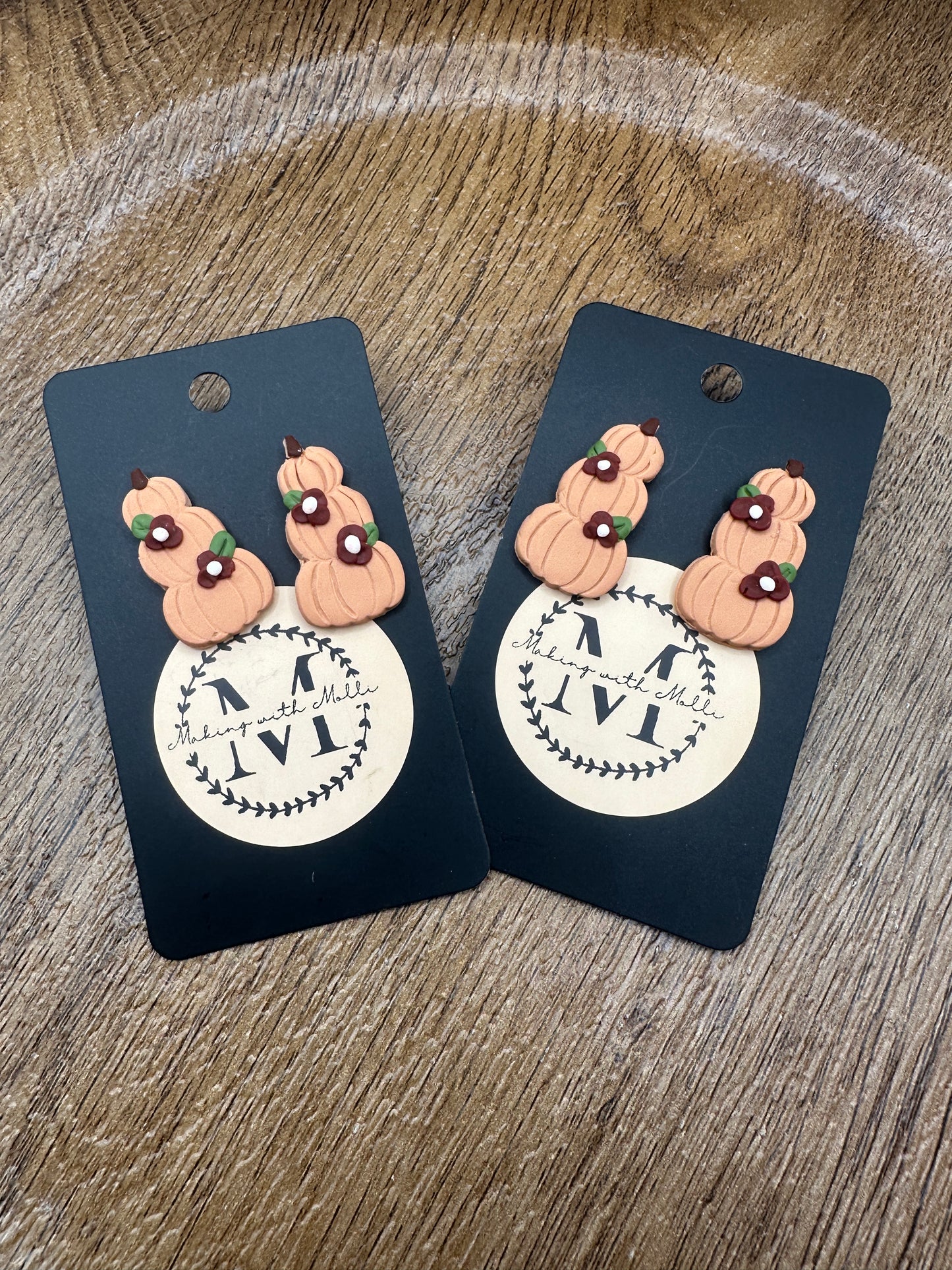 Stack Pumpkins with Maroon Flowers