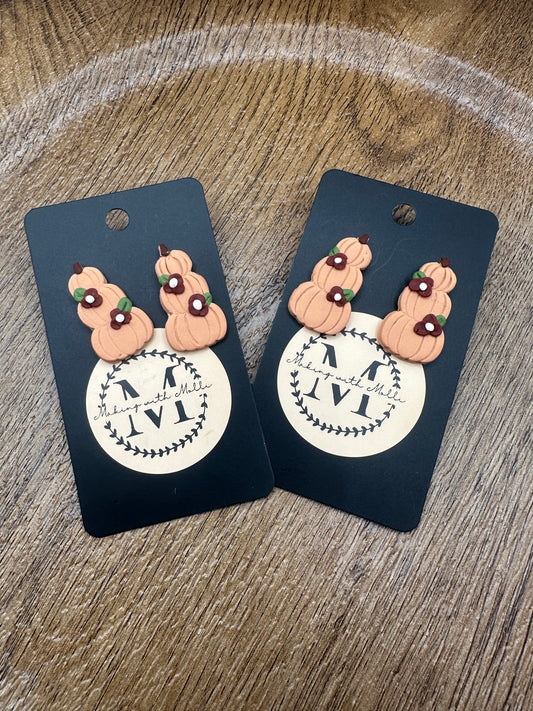 Stack Pumpkins with Maroon Flowers